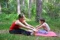 Fitness mother with her 9 years old son. Sports mom with kid doing morning work-out at park. Mum and child do the Royalty Free Stock Photo