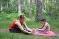 Fitness mother with her 9 years old son. Sports mom with kid doing morning work-out at park. Mum and child do the Royalty Free Stock Photo