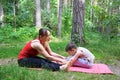 Fitness mother with her 9 years old son. Sports mom with kid doing morning work-out at park. Mum and child do the Royalty Free Stock Photo