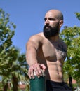 Fitness muscular man looking at the left in a public park