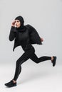 Fitness muslim woman posing running jumping isolated over white wall background Royalty Free Stock Photo