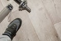 Fitness objects isolated on wooden background. Black Sneakers, dumbbells.