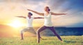 Couple making yoga warrior pose outdoors Royalty Free Stock Photo