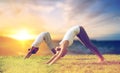 Smiling couple making yoga dog pose outdoors Royalty Free Stock Photo