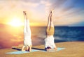 Couple doing yoga headstand on mat outdoors Royalty Free Stock Photo