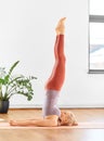 Woman doing yoga in shoulderstand at home