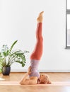 Woman doing yoga in shoulderstand at home