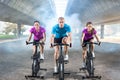 Fitness people riding exercise bikes Royalty Free Stock Photo