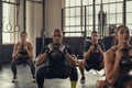 Fitness people squatting with kettlebell Royalty Free Stock Photo