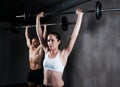 Fitness, people and weightlifting with barbell for intense training, exercise or bodybuilding at gym. Fit, active and