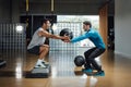 Fitness personal trainer teaching squatting pose while holding medicine ball Royalty Free Stock Photo