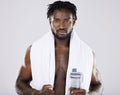 Fitness, portrait and black man with towel and water for sports in studio for strong body muscle. Health and wellness of Royalty Free Stock Photo