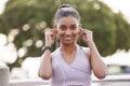 Fitness, portrait of happy woman with earphones in park on workout break listening to music or podcast. Exercise Royalty Free Stock Photo