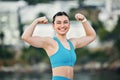 Fitness, portrait and woman flexing muscle, arms or biceps after strength training, workout or exercise for power. Smile Royalty Free Stock Photo