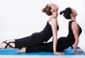 Fitness practice, group of two beautiful fit young people working out in sports club, doing stretching exercises