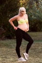 Fitness pregnant woman feeling her baby push