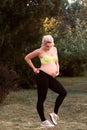 Fitness pregnant woman feeling her baby push