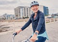 Fitness, promenade and woman riding a bicycle for exercise, health and wellness by the beach. Sports, smile and portrait Royalty Free Stock Photo