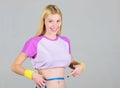 Fitness result. Calorie burn fitness exercise. Weight loss. Fitness and health. Female slim waist belly and tape measure Royalty Free Stock Photo