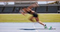 Fitness, run and fast blur athlete running on a race track for sports, athletics and exercise on the track. Workout