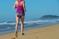 Fitness and running on beach, woman runner legs in shoes on sand near sea, healthy lifestyle and sport