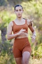 Fitness, running and music with woman in nature for training, jogging and cardio with bluetooth earphones. Sprinting Royalty Free Stock Photo