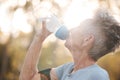 Fitness, senior woman and drinking water during a break from exercise workout or training in a park. Elderly woman Royalty Free Stock Photo