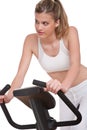 Fitness series - Young woman on exercise bike Royalty Free Stock Photo