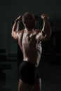 Fitness Shaped Muscle Man Posing In Dark Gym Royalty Free Stock Photo