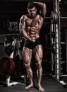 Fitness shaped muscle man posing on dark gym Royalty Free Stock Photo