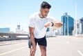 Fitness, smart watch and man in city for time, heart rate and cardio for running, exercise and workout. Wellness, sports Royalty Free Stock Photo