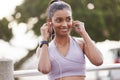 Fitness, smile and woman with earphones in park on workout break listening to music or podcast. Exercise, training and Royalty Free Stock Photo