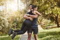 Fitness, spinning and couple hug in park outdoors for exercise, training and running for cardio workout. Dating, happy