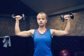 Fitness. Sport concept. Workout. Blonde girl holds black dumbbells. Fitness girl. Healthy lifestyle. Training. Workout. Woman hold