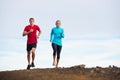 Fitness sport couple running jogging outside on trail Royalty Free Stock Photo