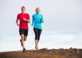 Fitness sport couple running jogging outside on trail Royalty Free Stock Photo