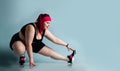 Fitness sport diet weight loss concept. Lucky plus-size girl overweight woman dieting working out doing stretching exercises