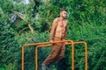 Fitness, sport, exercising, training and lifestyle concept - young man doing triceps dip on parallel bars outdoors Royalty Free Stock Photo