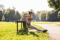 Fitness, sport, exercising, training and people concept - couple doing triceps dip exercise on city street bench. Royalty Free Stock Photo