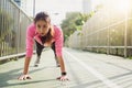 Fitness sport girl fashion sportswear doing yoga fitness exercise in street. Fit young asian woman doing training workout in morni