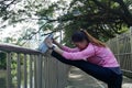 Fitness sport girl fashion sportswear doing yoga fitness exercise in street. Fit young asian woman doing training workout. Royalty Free Stock Photo