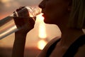 woman drinking water from bottle on beach Royalty Free Stock Photo