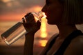 woman drinking water from bottle on beach Royalty Free Stock Photo