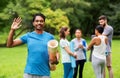 Smiling man with yoga mat over group of people Royalty Free Stock Photo