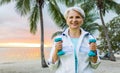 Senior woman with dumbbells exercising at park Royalty Free Stock Photo