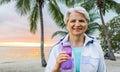 Sporty senior woman with bottle of water at park Royalty Free Stock Photo