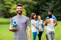 Smiling man with yoga mat over group of people Royalty Free Stock Photo