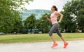Woman with earphones running at park Royalty Free Stock Photo