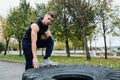 Fitness sport man workout outdoor. with tractor tire. Royalty Free Stock Photo