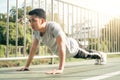 Fitness sport men fashion sportswear doing yoga fitness exercise in street. Fit young asian man doing training workout. Royalty Free Stock Photo